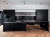 Kitchen, Pendant Lighting, Medium Hardwood Floor, Cooktops, Wall Oven, Refrigerator, Drop In Sink, Stone Slab Backsplashe, Ceiling Lighting, and Engineered Quartz Counter Main Kitchen   Photo 2 of 10 in PITCH Studio by Baky Soumare