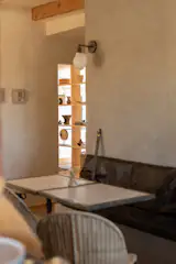 Custom built in bench slathered with Roman Clay features antique marble and steel bistro tables 