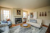 Living Room, Sofa, Lamps, Table Lighting, Wood Burning Fireplace, Coffee Tables, Accent Lighting, Medium Hardwood Floor, and End Tables Sitting Room/Parlor  Photo 3 of 17 in The Betsy Searle Place by Sadie Halliday