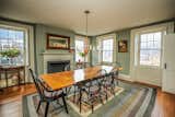 Dining Room, Table, Wood Burning Fireplace, Chair, Medium Hardwood Floor, and Pendant Lighting Formal Dining Room  Photo 5 of 17 in The Betsy Searle Place by Sadie Halliday