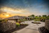 Exterior, Metal Roof Material, and House Building Type The home welcomes owners with a gracious circular designed driveway.   Photo 7 of 8 in Hokulia’s 81-6575 Hia Ai Ono Place by Luxury Design
