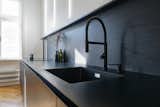 Kitchen, Drop In Sink, Medium Hardwood Floor, Open Cabinet, Wood Backsplashe, Wall Lighting, Cooktops, and Laminate Counter Kitchen  Photo 11 of 18 in BJM Apartment by B2 Architecture / Barbara Bencova