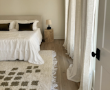Featuring custom and locally made wood nightstands, and a rug imported from the beloved Marrakech. 