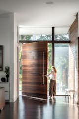 Doors, Wood, Exterior, and Swing Door Type The home's 10.5' tall pivot door.  Photo 5 of 20 in Catamaran House by Lear Studio Architects