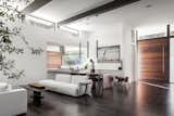 Living Room, Sofa, Pendant Lighting, Chair, Dark Hardwood Floor, Accent Lighting, and Coffee Tables The great room filled with natural daylight.  Photo 6 of 20 in Catamaran House by Lear Studio Architects