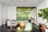 Living Room, Sofa, Dark Hardwood Floor, Accent Lighting, Gas Burning Fireplace, Ottomans, Media Cabinet, Recessed Lighting, and End Tables A view out to the urban patio.  Photo 7 of 20 in Catamaran House by Lear Studio Architects