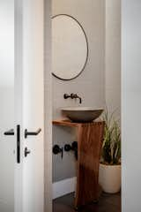 Bath Room, Vessel Sink, Dark Hardwood Floor, Wood Counter, and Accent Lighting A unique pedestal sink gives the powder bath warmth.  Photo 15 of 20 in Catamaran House by Lear Studio Architects