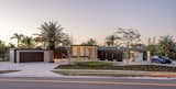 Exterior, Stone Siding Material, Metal Roof Material, Wood Siding Material, Flat RoofLine, Stucco Siding Material, Hipped RoofLine, House Building Type, and Metal Siding Material Evening View from the Street  Photo 7 of 16 in Lear Residence by Lear Studio Architects