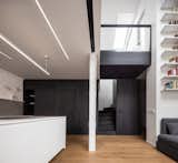 Kitchen, White Cabinet, Pendant Lighting, Ceiling Lighting, Track Lighting, and Medium Hardwood Floor  Photo 2 of 26 in Loft Apartment With Black Box by Komon Architekti