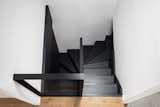 Staircase, Metal Railing, Glass Railing, and Wood Tread  Photo 15 of 26 in Loft Apartment With Black Box by Komon Architekti