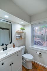 A second en suite full bathroom provides convenient, private access for any guests who reside in the primary bedroom.  Photo 8 of 19 in Schoolhouse 82 by Dustin Tomes