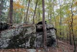 Massive rock formations create unique landscapes within the forested areas of the property.  Photo 13 of 19 in Schoolhouse 82 by Dustin Tomes