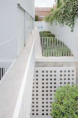 View from the entrance to the plot. The
pedestrian access goes through a bridge crossing
over the basement courtyard.
Big steel sliding doors close the windows on the
ground floor and on the basement.  Photo 5 of 9 in Galgo House by M&E Clara Murado y Juan Elvira