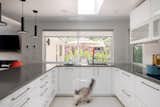 Framed patio views through the kitchen window enhance indoor-outdoor connection.