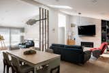 The kitchen serves as a central vantage point, offering clear views into the adjacent living and dining spaces, as well as the entry zone. 