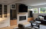In the basement media room, custom cabinetry integrates seamlessly with the design, hiding all tech components in a way that preserves the room's clean, spacious aesthetic. 