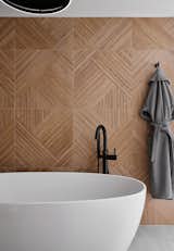 A simple, Japandi-influenced free-standing tub creates a spa-like experience at the end of a long day.