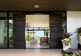 Front Grand Entrance: Oversized custom sugi-ban clad doors with bronze hardware graciously welcome visitors.  Photo 4 of 24 in Ocean Retreat Along Waimanalo Coast, Hawaii by Maile Kop
