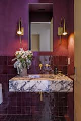Red zellige tiling and double sconce combo with a stoneland sink