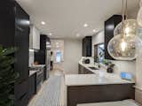 Updated kitchen with custom maple cabinetry and waterfall quartz counters
