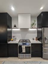 Range features custom hood and open shelving with underlighting.