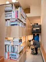 The bike ramp features a bike storage nook. The knee wall for the living area above includes cutouts for our client's expansive cookbook collection. 
