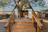 The ADU was located far enough away from the roots of the live oak tree so as not to harm it, and the deck was constructed around the same tree