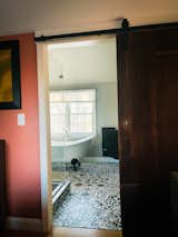 A look into the master bathroom from the master bedroom. Barn door was acquired from an architectural salvage place in NH. The claw foot tub is my favorite. 