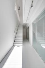 Hallway and Concrete Floor Lower Level Bedrooms  Photo 2 of 8 in House White by Archiplus International Limited