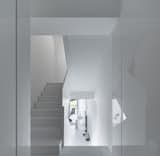 Hallway and Concrete Floor Intermediate Level  Photo 6 of 8 in House White by Archiplus International Limited