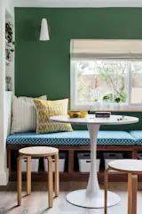 A study/play nook provides toy storage and seating adjacent to the family room. 