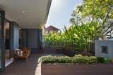 Outdoor, Front Yard, Large Patio, Porch, Deck, Concrete Fences, Wall, Shrubs, and Gardens Porch  Photo 3 of 36 in Tropical Living by Provolk Architects