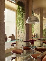 Dining Room, Table, Ceiling Lighting, Pendant Lighting, and Concrete Floor Dining area. Italian chrome and glass furniture pieces from the 1970s (design by Casa Josephine Studio)  Photo 2 of 10 in Casa Josephine Studio -apartment Lavapies, Madrid by Pablo Lopez Navarro