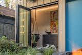 Doors, Exterior, Folding Door Type, and Metal Bifold doors turn the small ground floor entryway into a serving area for outdoor entertaining.  Photo 7 of 21 in The Snug (ADU) by Via Chicago