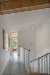 Hallway and Concrete Floor Upper stairwell
Exposed LVL beam and American mahogany handrails  Photo 5 of 12 in Tuwanek Forest Retreat by Sharif Senbel