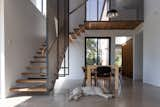 Dining Room, Ceiling Lighting, Table, Chair, and Concrete Floor Stairs  Photo 8 of 18 in Minnedosa House by design-built