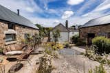The barn conversion sits around a sunny wildflower filled courtyard
