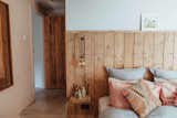 Warm pink tones and reclaimed wood in the master bedroom