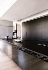 Minimalist Kitchen with reflective island cabinet fronts to reflect the beauty of the hardwood flooring
