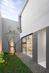 Outdoor, Back Yard, Trees, Shrubs, Grass, and Landscape Lighting View of the backyard.  Photo 7 of 11 in 1500 Haus by Studio Lawang