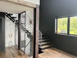 Raw metal mesh devider,and railings and recycled metal beams. Custom made stair threads on amazon metal stair stringer 