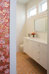 The girl's bathroom includes Anthropologie hardware and concrete siding and ceiling.