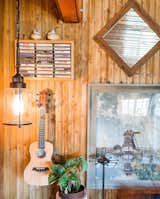 Another example of the quiet study area. A low hanging nautical light and windmill print along with a vintage spinning jewelry hanger.