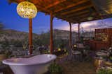 Desert dusk over the back porch. A beautiful space for a small gathering and a bath! Succulents abound, a herringbone panel bench to pull up to the bath if you need more counter space. And there is a build in counter, again from black limba, on the opposite side of the tub.