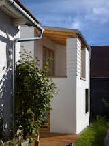 Exterior, Stucco Siding Material, Wood Siding Material, Metal Roof Material, House Building Type, and Shed RoofLine  Photo 7 of 29 in House in the Courtyard by IGLOO ARCHITEKTI