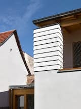 Exterior, Wood Siding Material, House Building Type, Stucco Siding Material, and Shed RoofLine  Photo 9 of 29 in House in the Courtyard by IGLOO ARCHITEKTI