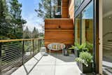 Concrete and cedar wood vibrantly interacting in the outdoor yet private balcony overlooking the local redwood and oak trees. 