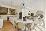 Spacious kitchen and dining area with the exposed board concrete motif used as backsplash. 