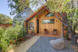 Spacious porch elegantly wrapped with natural Douglas-fir flooring seamlessly fitting in with its single-family home. 