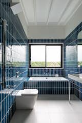 Bath Room, Porcelain Tile Floor, Two Piece Toilet, Pedestal Sink, Wall Lighting, Subway Tile Wall, and Drop In Tub The 'Boys Bathroom'  Photo 7 of 21 in The Balmoral Beach House by Queen Mab Design Studio